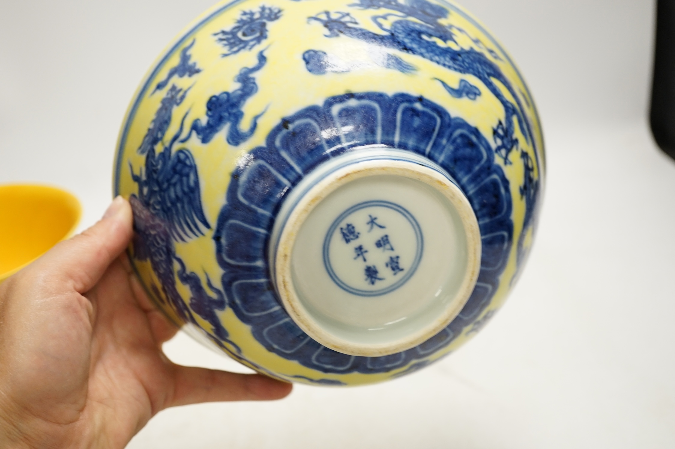 A Chinese yellow ground underglaze blue 'dragon' bowl, boxed, a yellow and green 'dragon' dish and a similar stem cup, yellow bowl 19.5cm diameter. Condition - good